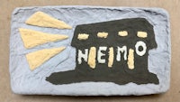 a piece of clay with the word nemo on it