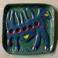 a ceramic plate with a dog on it