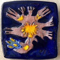 a blue tile with a yellow flower on it